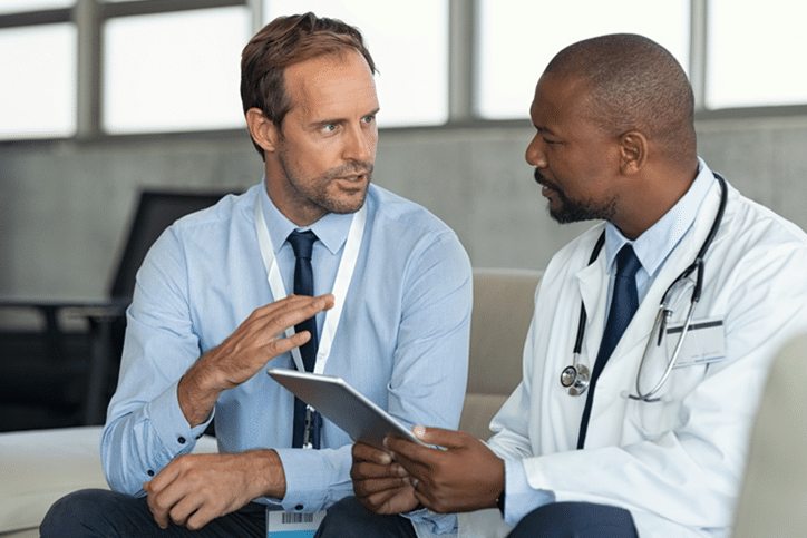 Medical Device Sales representative discussing product with doctor